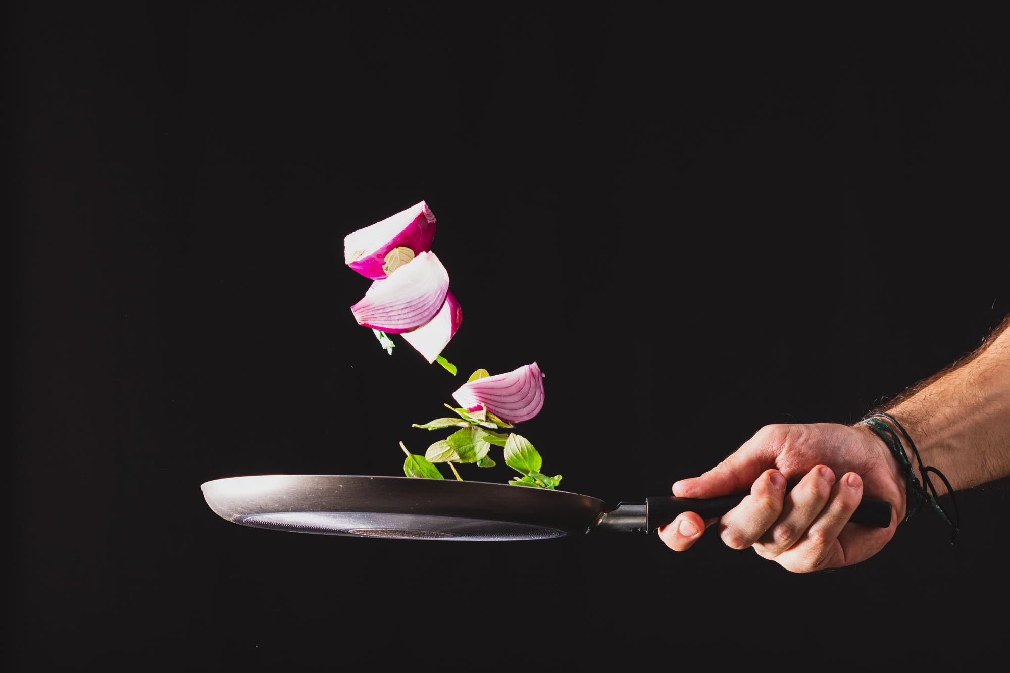 Chef preparing modern plated dish with neon kitchen tools